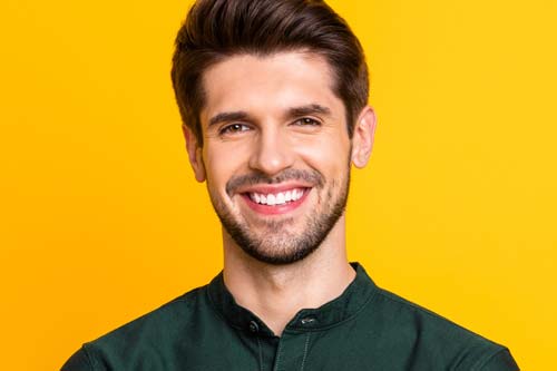 cosmetic dentistry man in green collar shirt