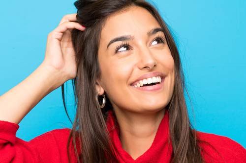 specialist services woman in red turtleneck smiling