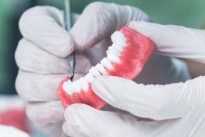 Dentist working on a pair of full bottom dentures