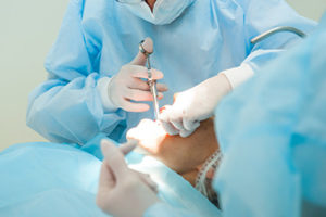 a dentist performing oral surgery