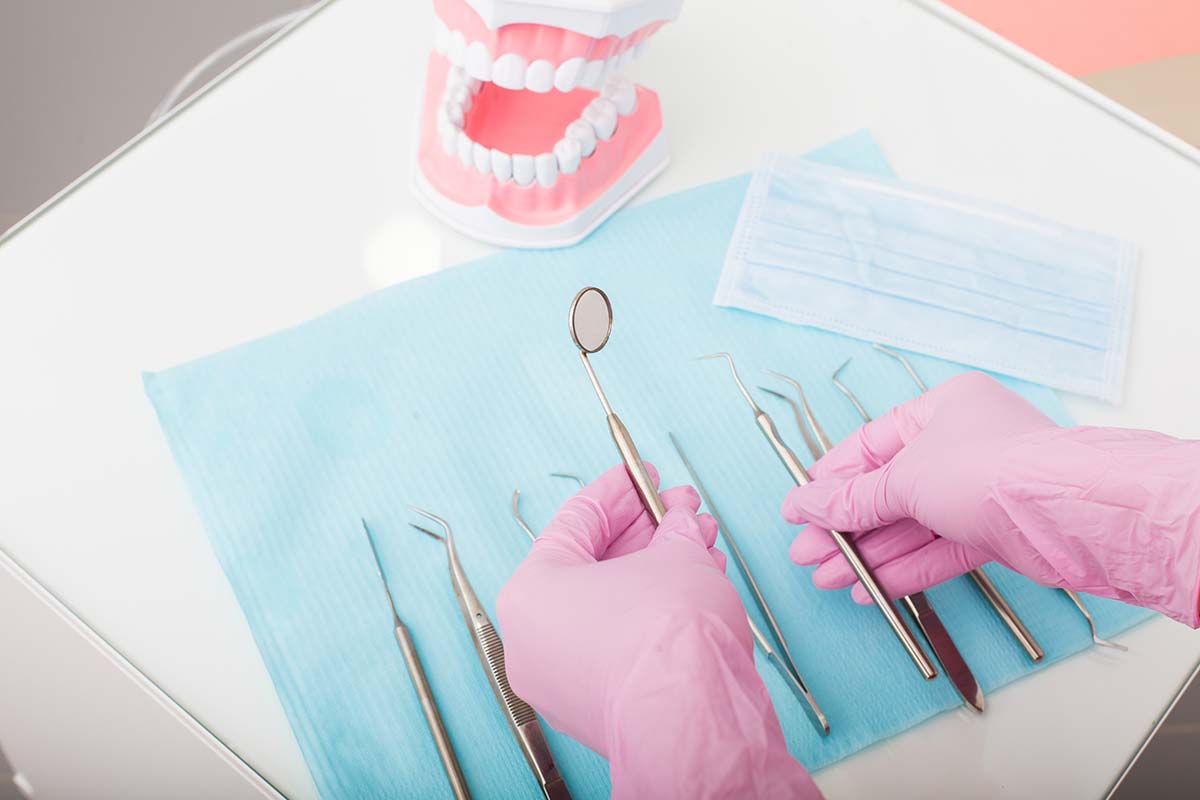 What Is A Dental Emergency a dentist prepares tools for a dental emergency