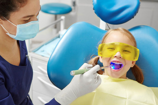 a young child getting help for pediatric dental emergency