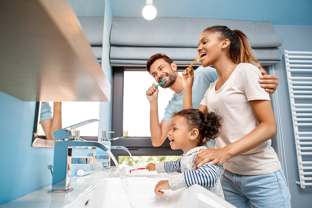 a family trying out different types of toothbrushes