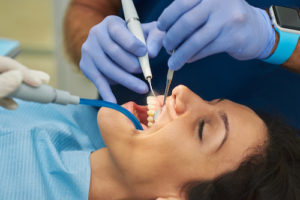 woman receives a tooth extraction 