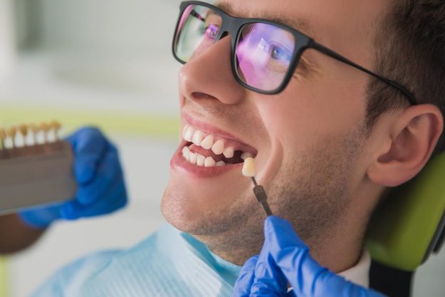 4 Benefits of Dental Implants a man is happy to receive his dental implant