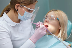 a woman receives treatment at a specialty dentist